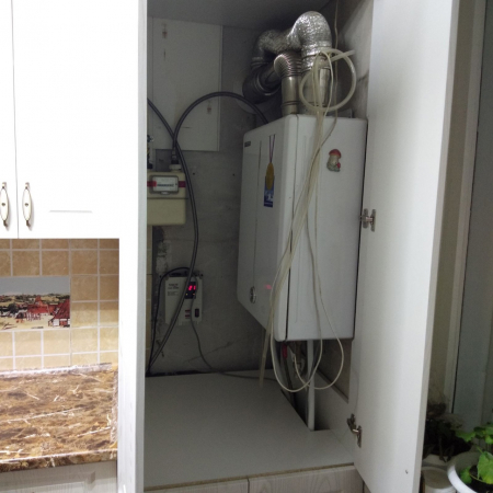 Кухня белого цвета со шкафом под газовый котел